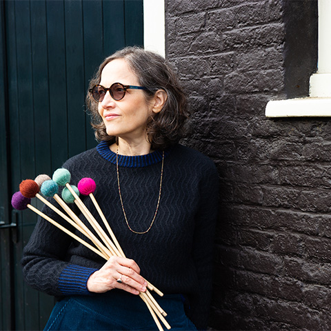 nancy zeltsman holding percussion instruments 