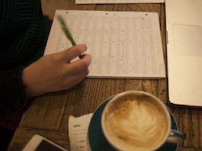 Person composing in front of a laptop