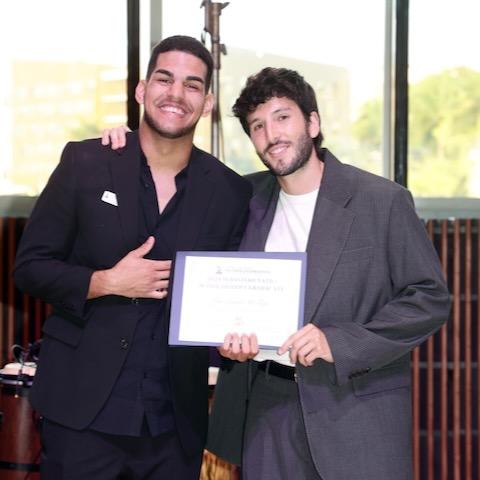 Leo Luna Roblejo and Sebastián Yatra pose with an award plaque