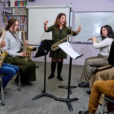 Music education students play in and conduct an ensemble