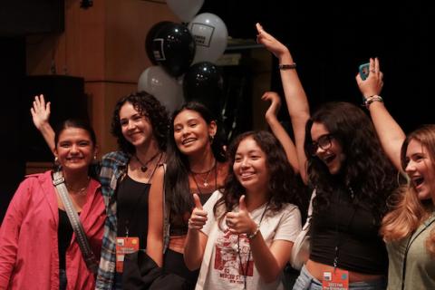 Smiling young women enjoying a festive gathering together.